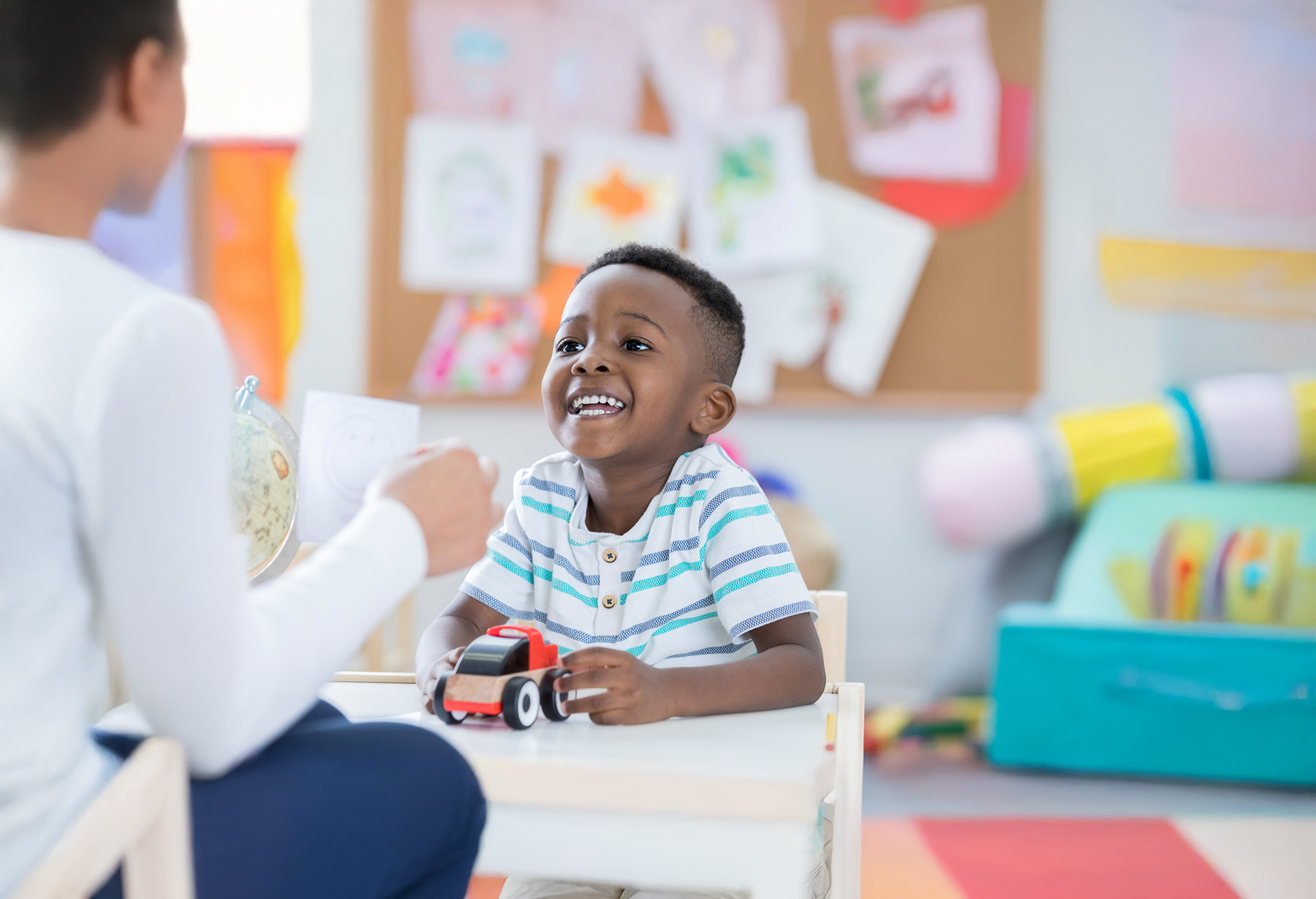 Young child practicing communication skills with pediatric speech therapist during play-based therapy session in Orlando