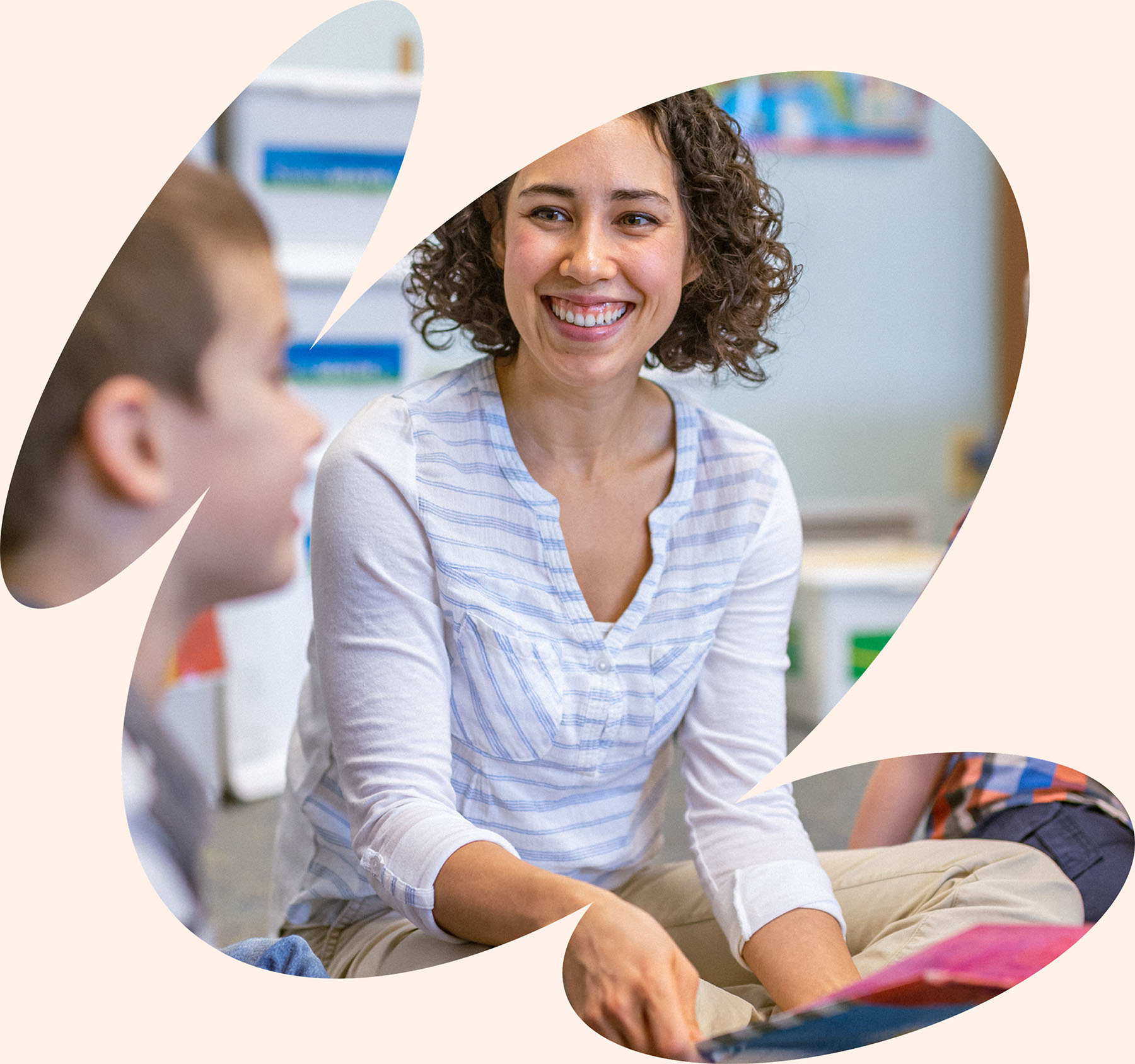 Pediatric therapist smiling and engaging with child during collaborative, parent-centered therapy session in Orlando