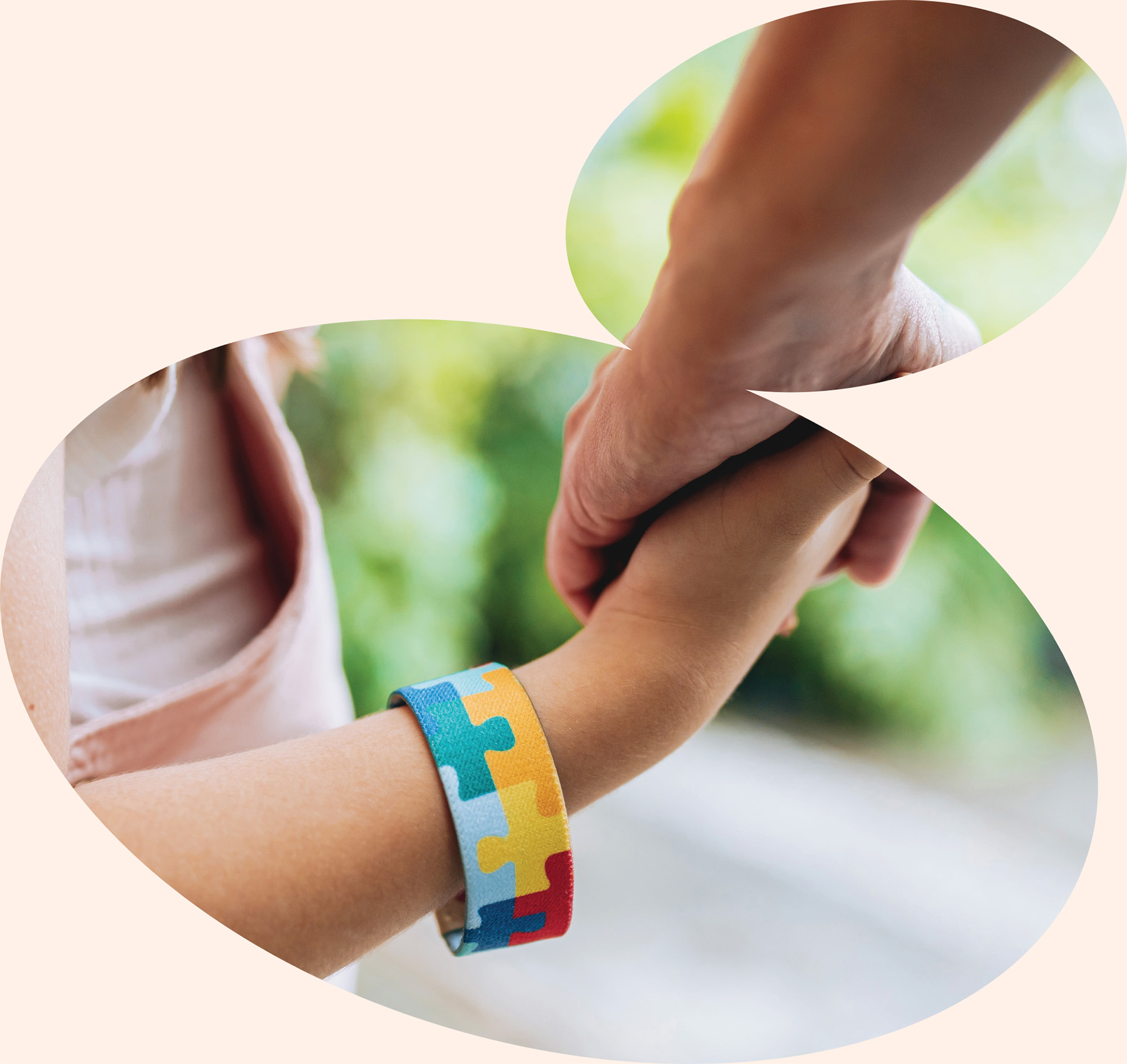 Caregiver holding child’s hand wearing autism awareness bracelet showing compassionate family centered pediatric therapy support