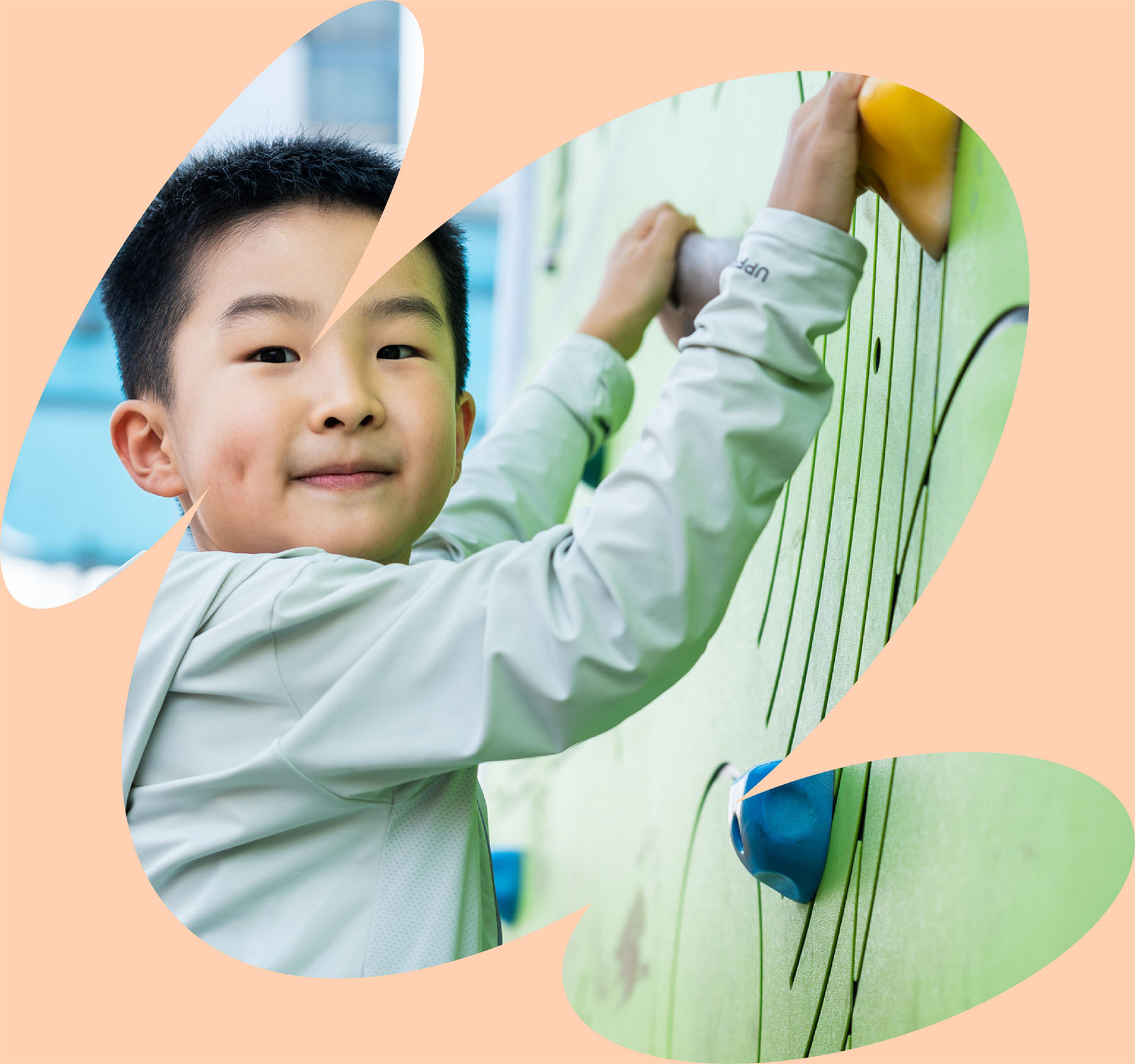 Child strengthening coordination and upper body control on indoor climbing wall during pediatric physical therapy