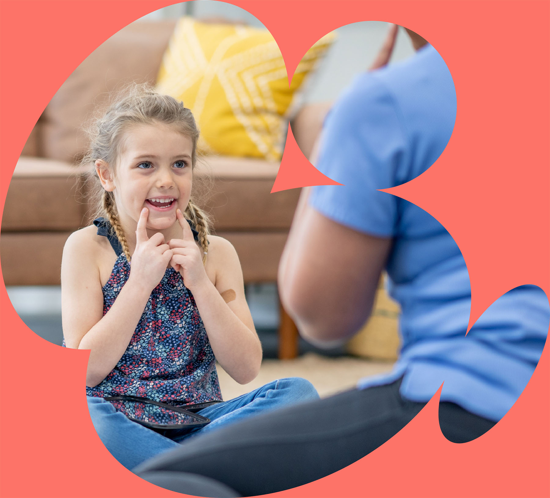 Young girl practicing articulation and speech sounds with therapist during pediatric speech therapy session