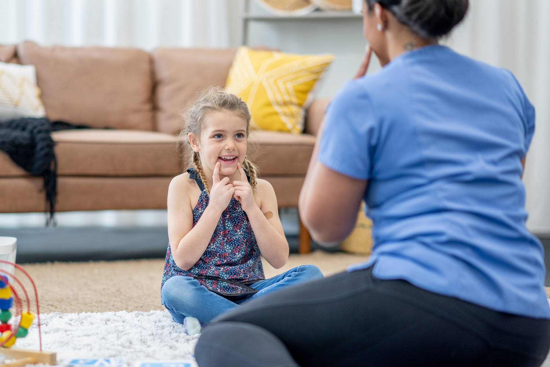 Child working on speech sounds and articulation with pediatric speech therapist during one-on-one therapy session in Orlando